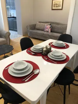 a white table with red napkins and plates on it at Ozcans Pera Flats 2 in Istanbul