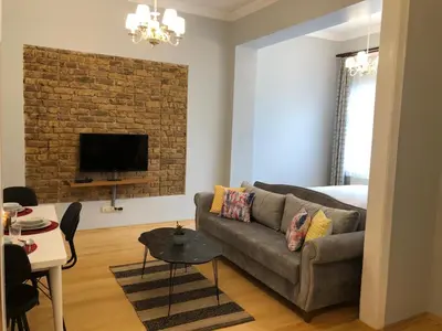 a living room with a couch and a bedroom at Ozcans Pera Flats 2 in Istanbul