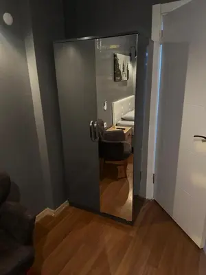 a mirror in a room with a chair and a bed at Besiktas Guest House in Istanbul