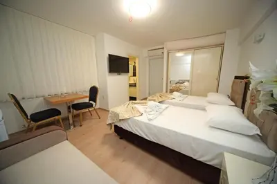 a bedroom with a bed and a desk and a table at Beyaz Köşk Hotel in Istanbul