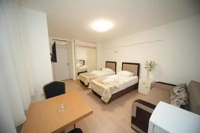a hotel room with two beds and a table at Beyaz Köşk Hotel in Istanbul