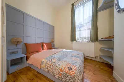 a bedroom with a large bed and a window at Stunning 5 Bedroom Sunlit Apartment Galata in Istanbul