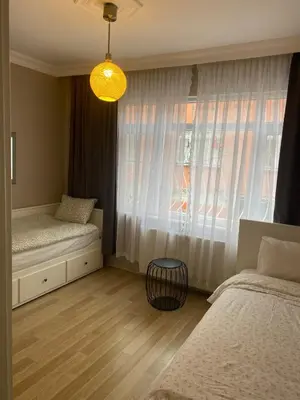 a bedroom with two beds and a window at sultans corner in Istanbul