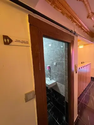 a door leading to a bathroom with a sink at Grand Süleymaniye Hotel in Istanbul
