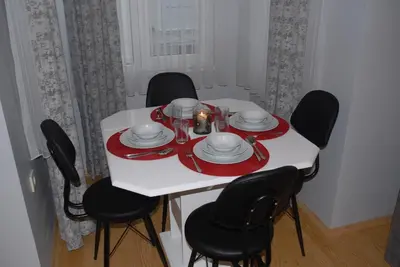 a white table with black chairs and a red and white plate at Ozcans Pera Flats 3 in Istanbul