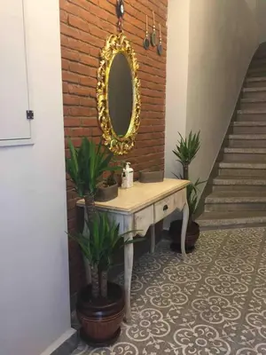 a dressing table with a mirror on a brick wall at Ozcans Pera Flats 3 in Istanbul