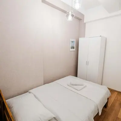 a small room with a bed and a white cabinet at Modern apartment in the center of Kadıköy in Istanbul