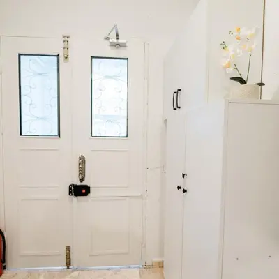 a white door with a window on it at Modern apartment in the center of Kadıköy in Istanbul