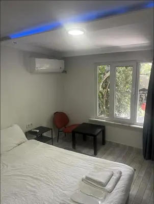 a room with a bed and a chair and windows at Şişli Suites - Room 14 in Istanbul
