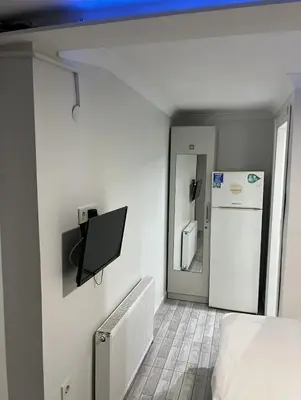 a room with a bed and a refrigerator at Şişli Suites - Room 14 in Istanbul