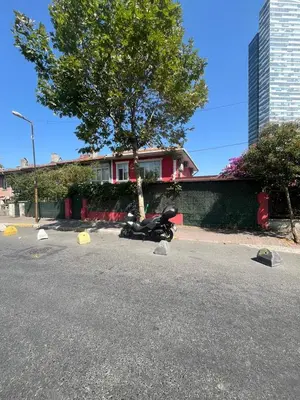 a motorcycle parked in a parking lot next to a house at Şişli Suites - Room42 in Istanbul