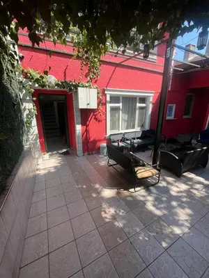 a red building with two benches in front of it at Şişli Suites - Room42 in Istanbul