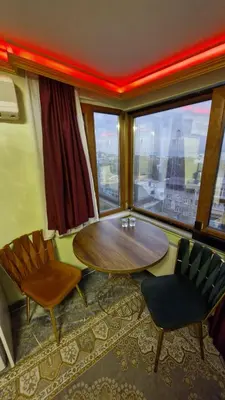 a room with a table and two chairs and a window at Gür Star Hotel in Istanbul
