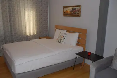 a small bedroom with a bed and a couch at Ozcans Pera Flats 8 in Istanbul
