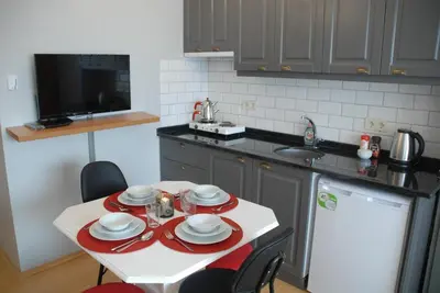 a kitchen with a table with plates and dishes on it at Ozcans Pera Flats 8 in Istanbul