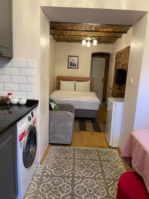 a bedroom with a bed and a washing machine at Ozcans Pera Flats 10 in Istanbul