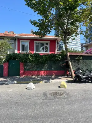 a red house with a motorcycle parked in front of it at Şişli Suites - Room41 in Istanbul