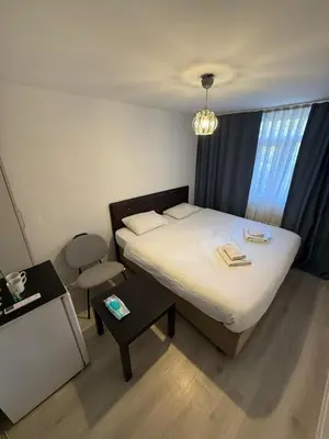a small bedroom with a bed and a chair at Şişli Suites - Room46 in Istanbul