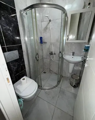 a bathroom with a shower and a toilet and a sink at Şişli Suites - Room46 in Istanbul