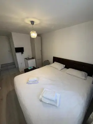 a bedroom with a large white bed with two towels on it at Şişli Suites - Room46 in Istanbul
