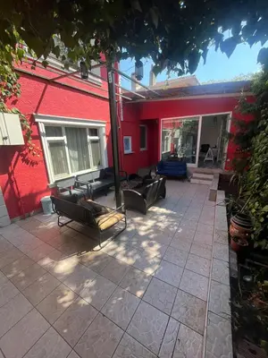 a patio with couches and a red building at Şişli Suites - Room47 in Istanbul