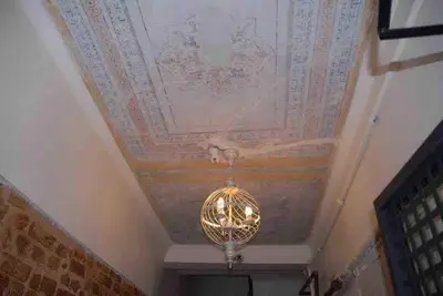 a chandelier hanging from a ceiling with a painted ceiling at Ozcans Sururi Pera Flats 2 in Istanbul