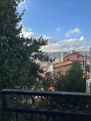 a view of a city from behind a bench at Ozcans Sururi Pera Flats 2 in Istanbul