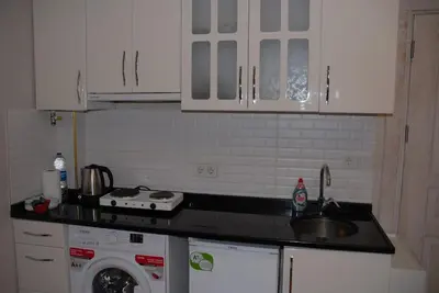 a kitchen with a sink and a washing machine at Ozcans Pera Sururi Flats 4 in Istanbul