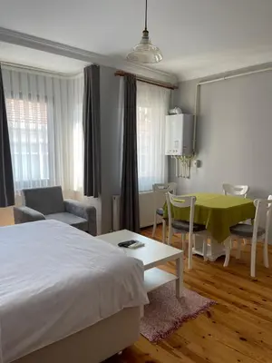 a bedroom with a bed and a table and chairs at Ozcans Sururi Pera Flats 8 in Istanbul