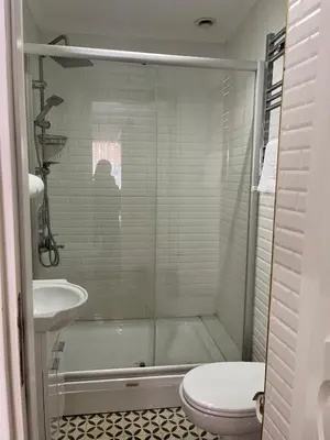 a bathroom with a shower and a toilet and a sink at Ozcans Sururi Pera Flats 8 in Istanbul