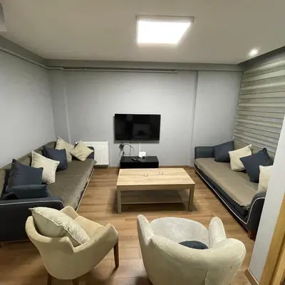 a living room with two couches and a tv at Modern Comfort Steps from Taksim in Istanbul