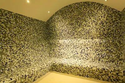 a bathroom with a large wall of mosaic tiles at Bright 2BR Home in Central Istanbul in Istanbul