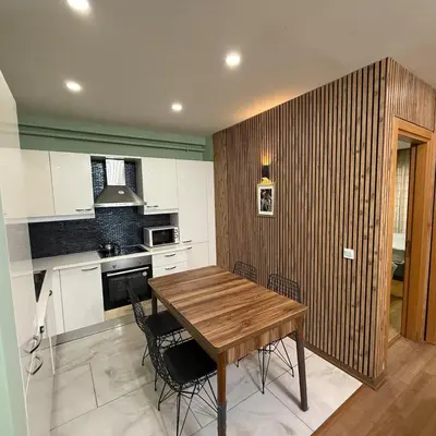 a kitchen with a wooden table and chairs at Bright 2BR Home in Central Istanbul in Istanbul