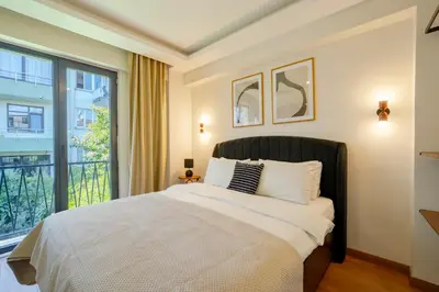 a bedroom with a bed and a large window at 3-Bedroom 2-Bathroom Duplex Apartment with Elevator in Istanbul