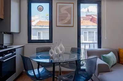 a kitchen with a glass table in a living room at 3-Bedroom 2-Bathroom Duplex Apartment with Elevator in Istanbul