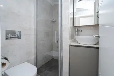 a bathroom with a shower and a toilet and a sink at 3-Bedroom 2-Bathroom Duplex Apartment with Elevator in Istanbul