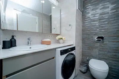 a bathroom with a sink and a washing machine at 3-Bedroom 2-Bathroom Duplex Apartment with Elevator in Istanbul
