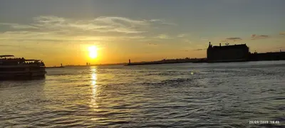 a sunset over a body of water with the sun setting at Sweet Home Kadikoy in Istanbul