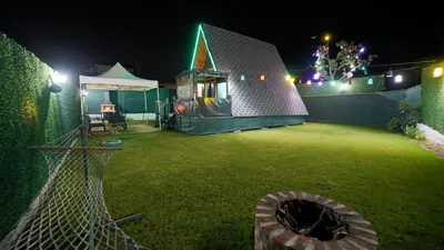a backyard with a play yard at night at Hilltop Bungalov Sapanca 3 in Sapanca