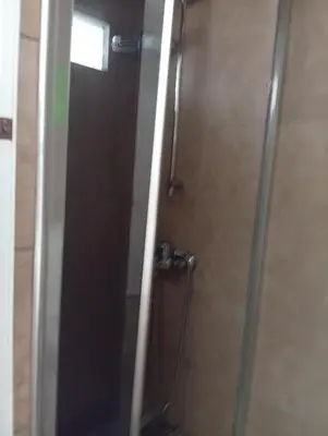 a bathroom with a shower with a glass door at As Pansiyon in Istanbul