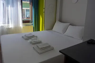a bedroom with a bed with towels on it at As Pansiyon in Istanbul