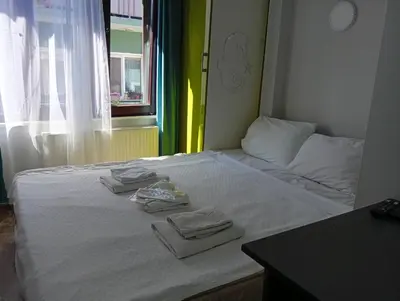 a white bed with two towels on top of it at As Pansiyon in Istanbul