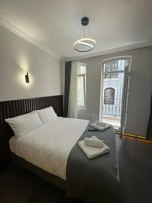 a bedroom with a large bed and a window at Nine Rooms by taksim in Istanbul