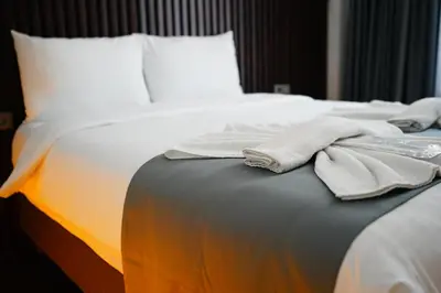 a bed with white sheets and towels on it at Nine Rooms by taksim in Istanbul