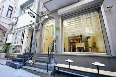 a dog sitting on a bench outside of a store at Nine Rooms by taksim in Istanbul