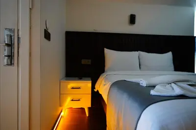 a bedroom with a bed with a nightstand and a bed sidx sidx at Kuyu Apartments near taksim in Istanbul