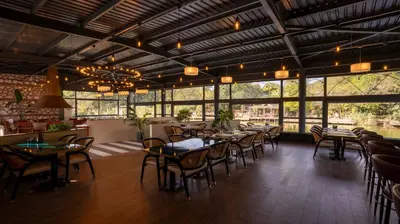 a dining room with tables and chairs and windows at Verona Ağva in Sile