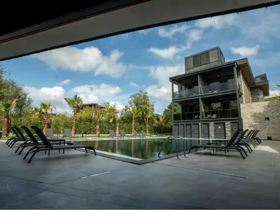 a house with a swimming pool and chairs around it at Verona Ağva in Sile