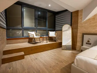 a bedroom with a bed and a table and chairs at Verona Ağva in Sile