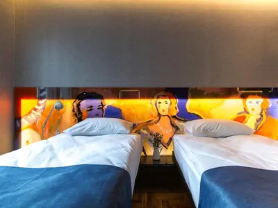 a bedroom with two beds and a wall with pictures at Lampa Design Hotel-Special Category in Istanbul